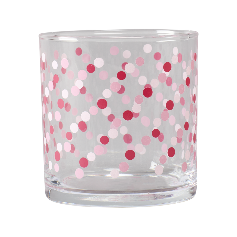 Clear glass candle holder with pink and red polka dots on a white background
