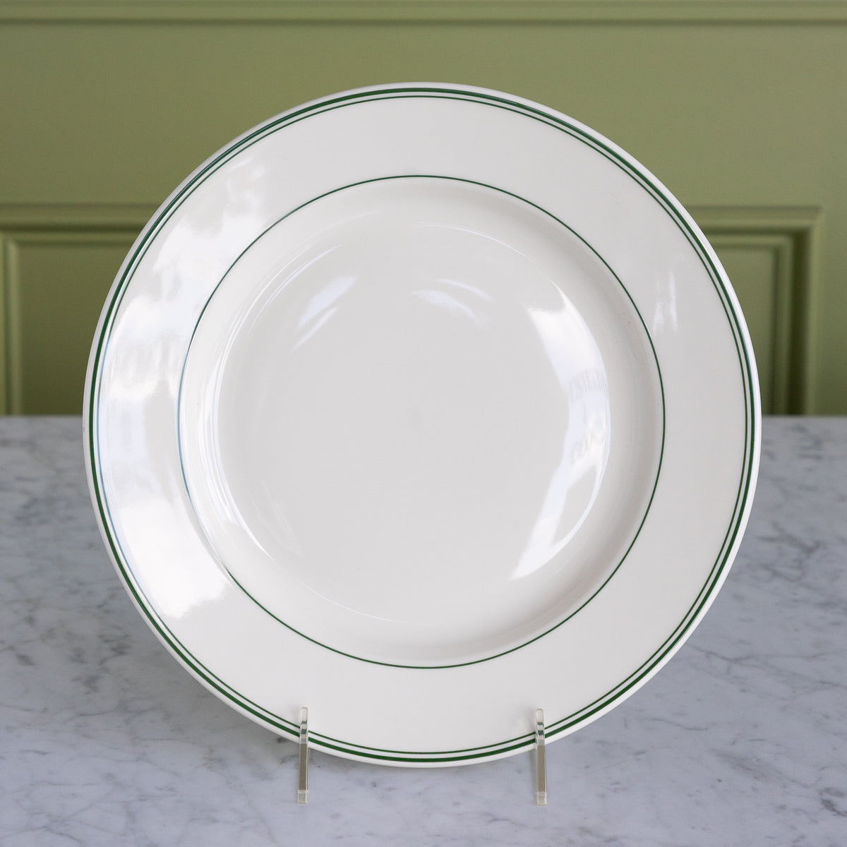 A white porcelain 11 and 1/8-inch main dinner plate with classic green stripes around the outer rim.