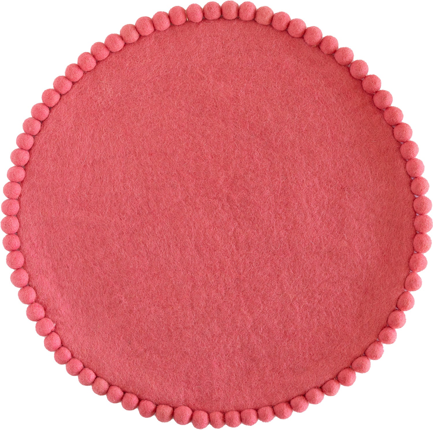 Pink colored round felt placemat with small pom poms around the edge. 