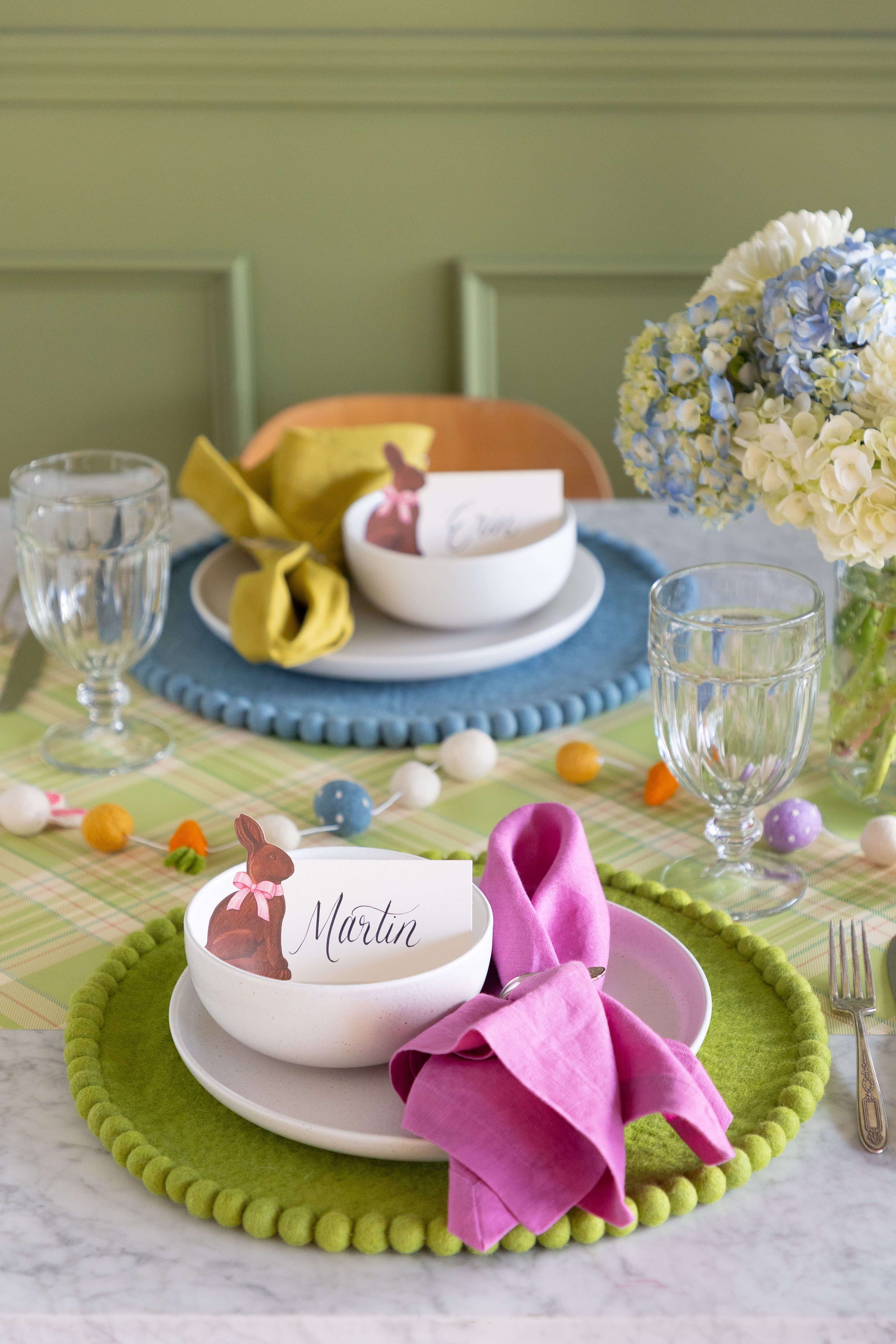 Easter-themed table setting with colorful decorations, Spring Green Pom Pom Felt Placemat, Hershey&