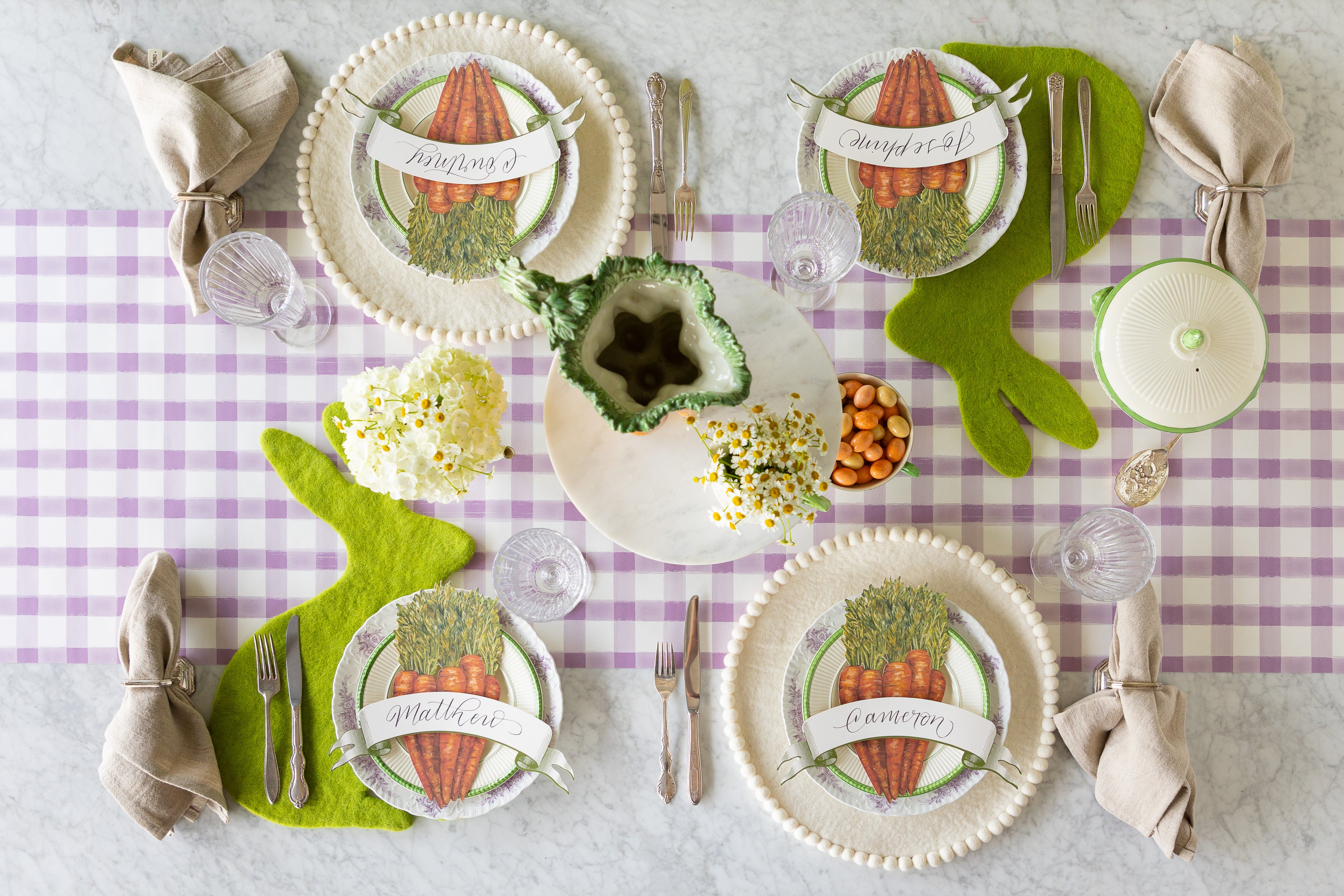 Easter-themed table setting with decorative plates, felt Spring Green Easter Bunny and Ivory Pom Pom Placemats, Carrots and Classic Moss Banner Table Accents.
