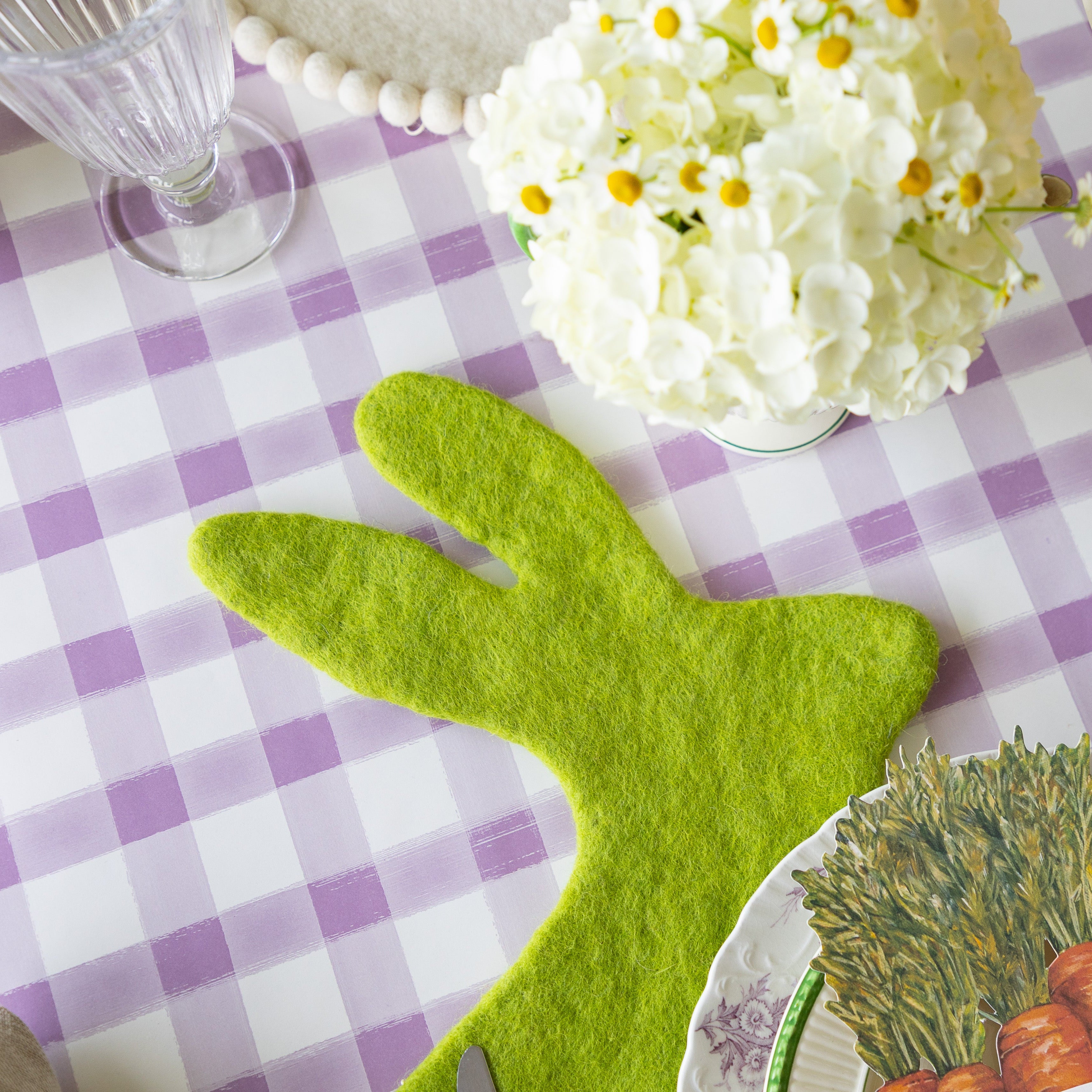 A close up of the Spring Green Felt Bunny Placemat on an Easter table setting.
