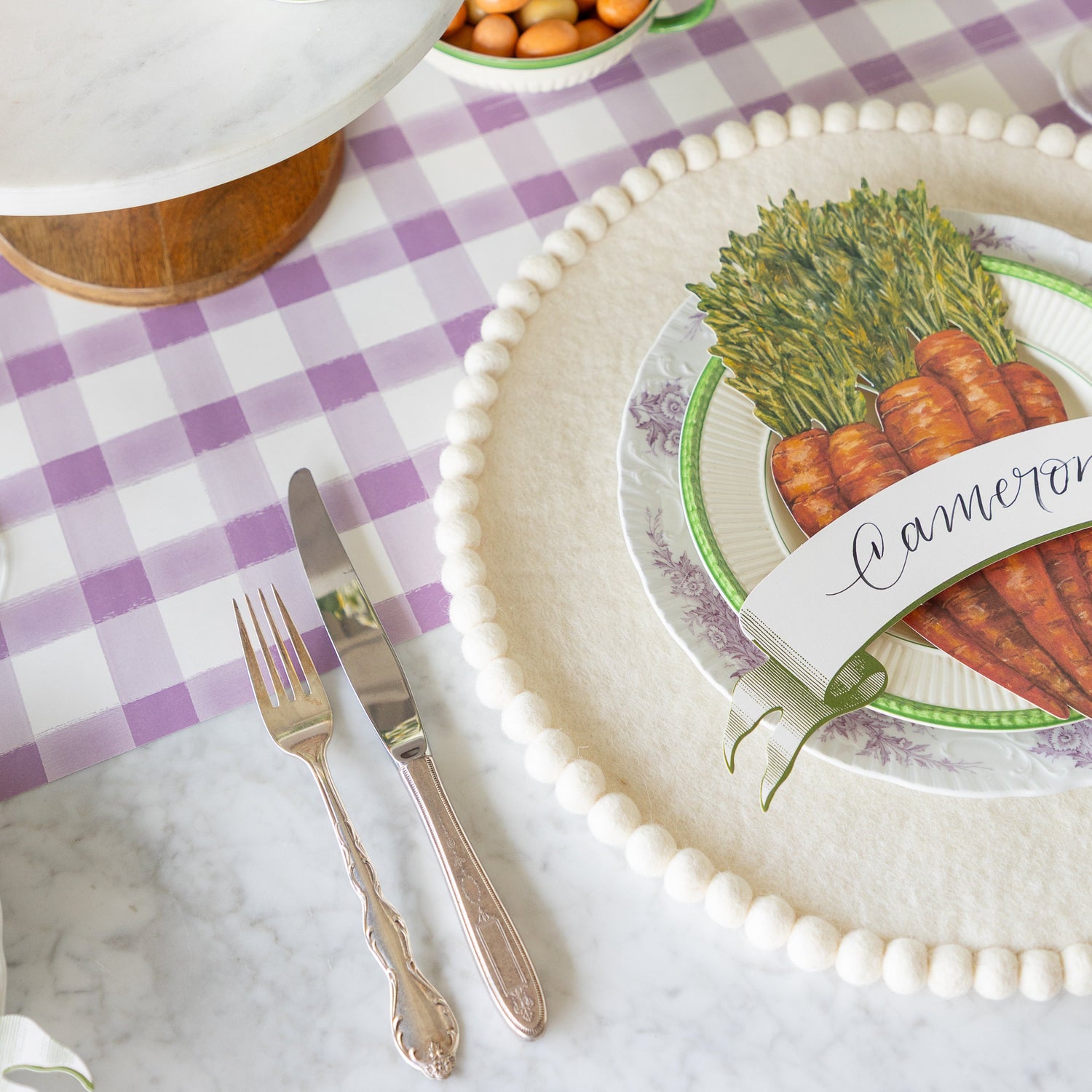 Spring-themed table setting with the Ivory Pom Felt Placemat on the Lilac Painted Check Runner.