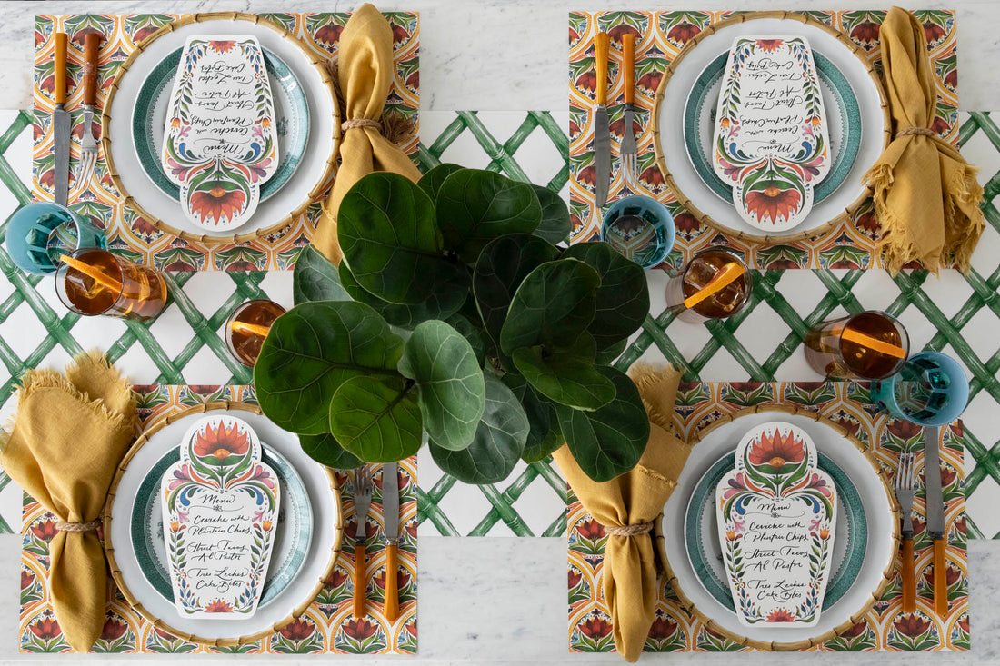The Fiesta Floral Placemat under a festive table setting for four, from above.