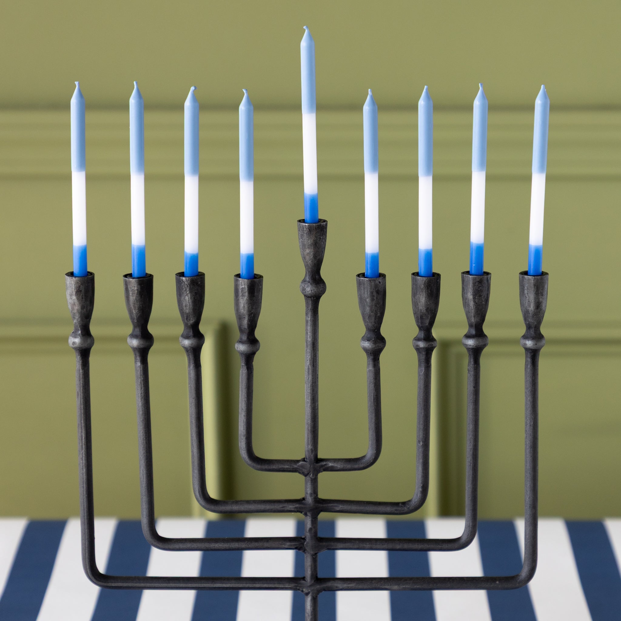 Liora Menorah with blue and white menorah candles on the Navy Classic Stripe Runner.