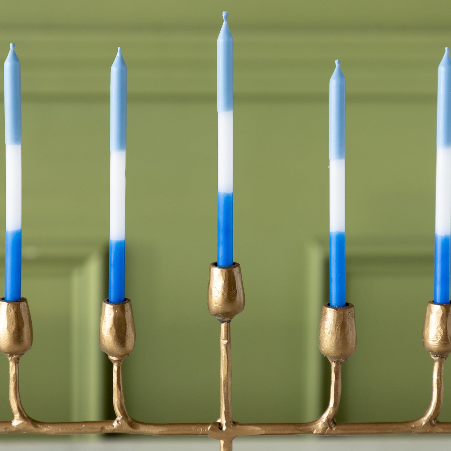Gold menorah with blue and white menorah candles.