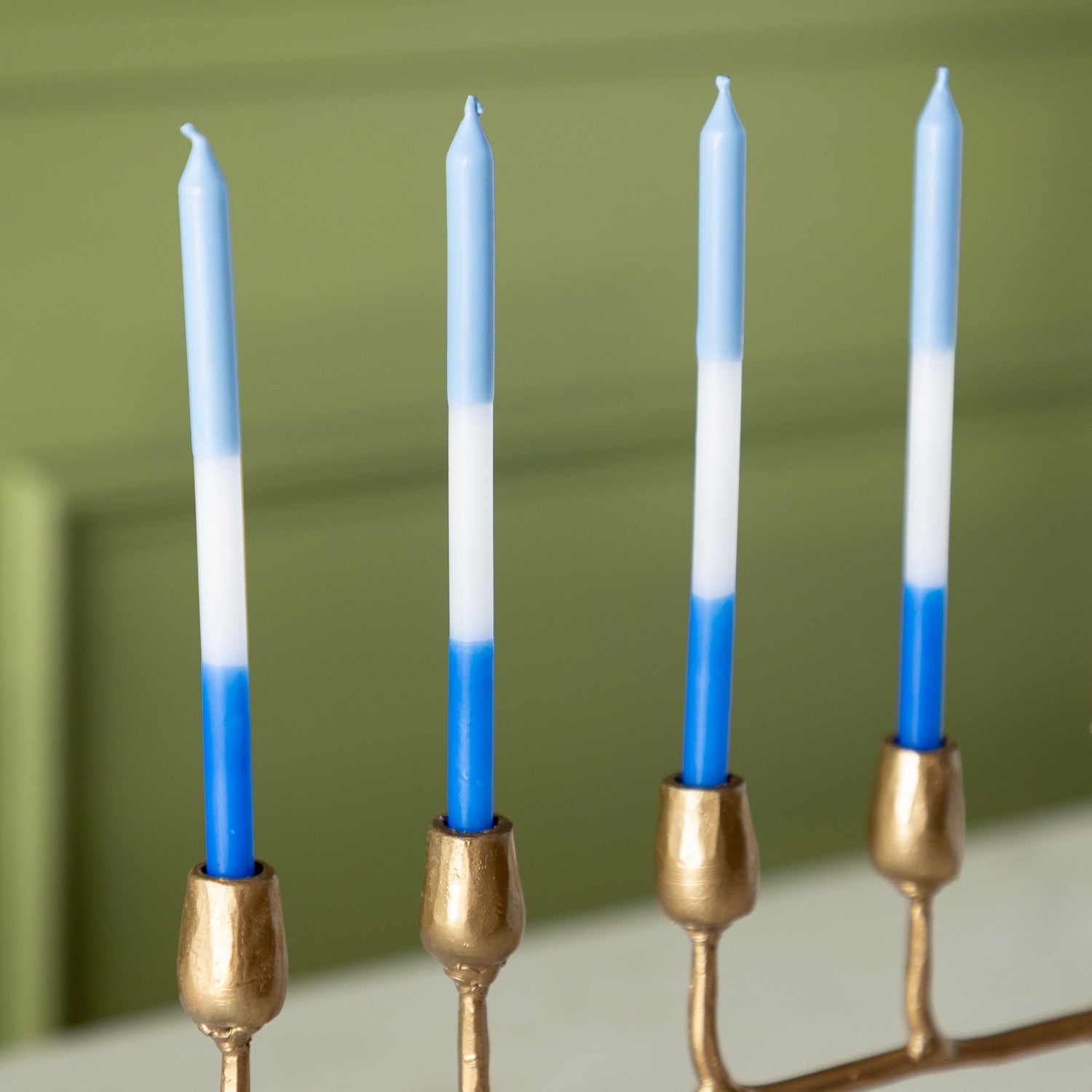 Gold menorah with blue and white menorah candles.