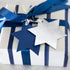 Gift wrapped in blue and white stripes with a Star of David tag on a neutral background.