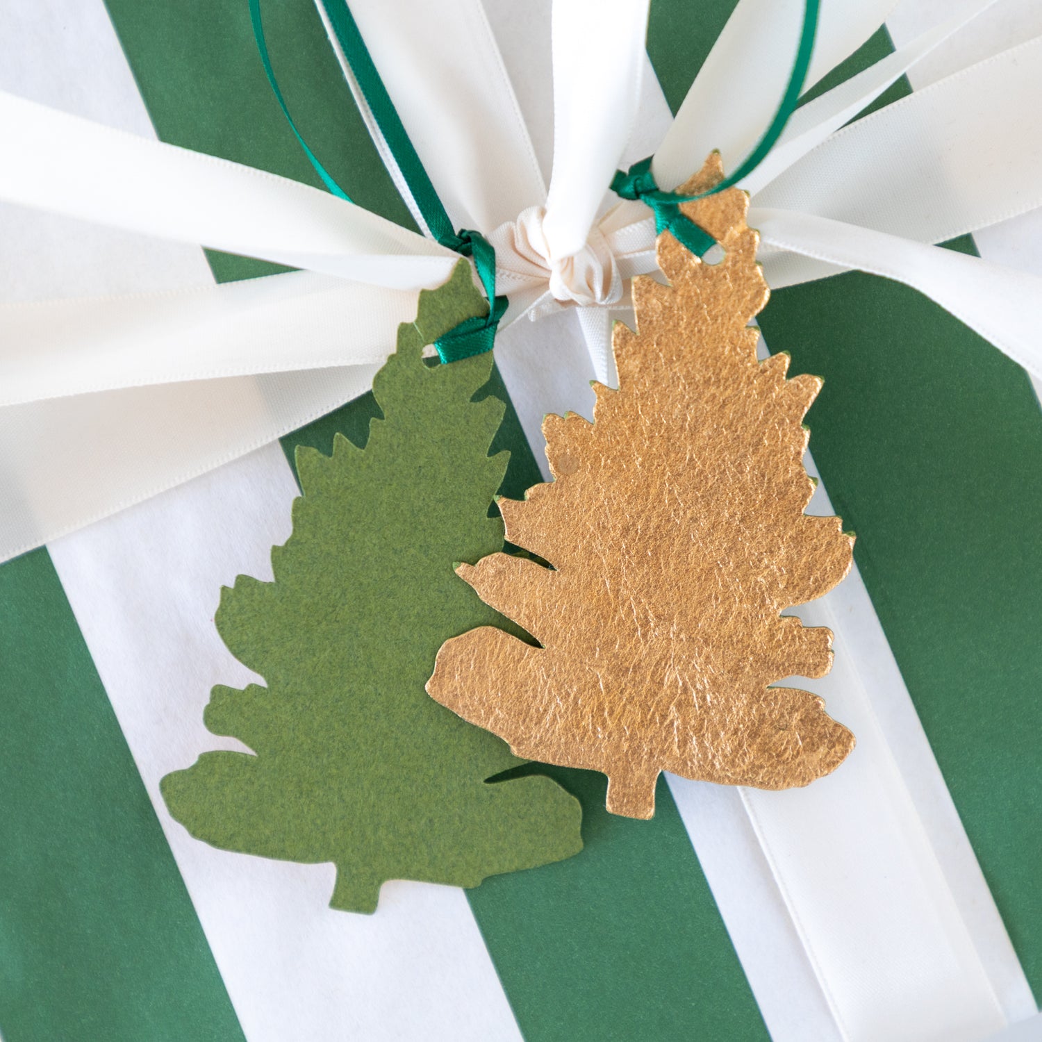Gold and green leaf-shaped decorations on a striped background.