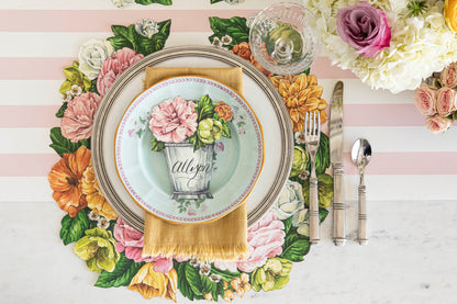 A table setting with plates, silverware, and a Hester &amp; Cook Die-cut Derby Wreath Placemat.