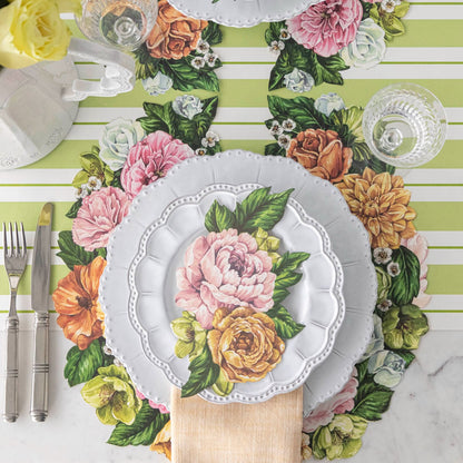 A set of Hester &amp; Cook paper placemats with a Die-cut Derby Wreath design featuring flowers.