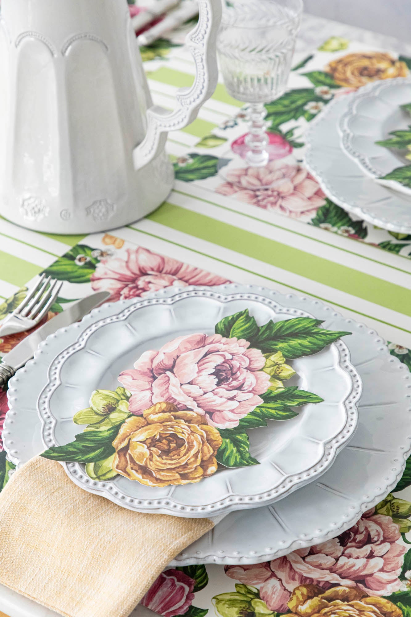 A table setting with a Hester &amp; Cook Garden Derby Table Accent and flowers on it.