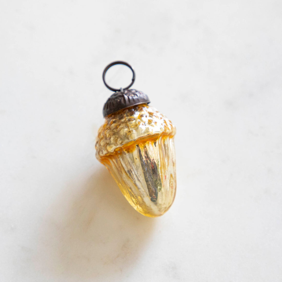 Amber glass acorn ornament.