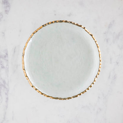 Annie Glass Edgy Salad Plate, adorned with a 24-karat gold band in an edgy shape, on a marble table.