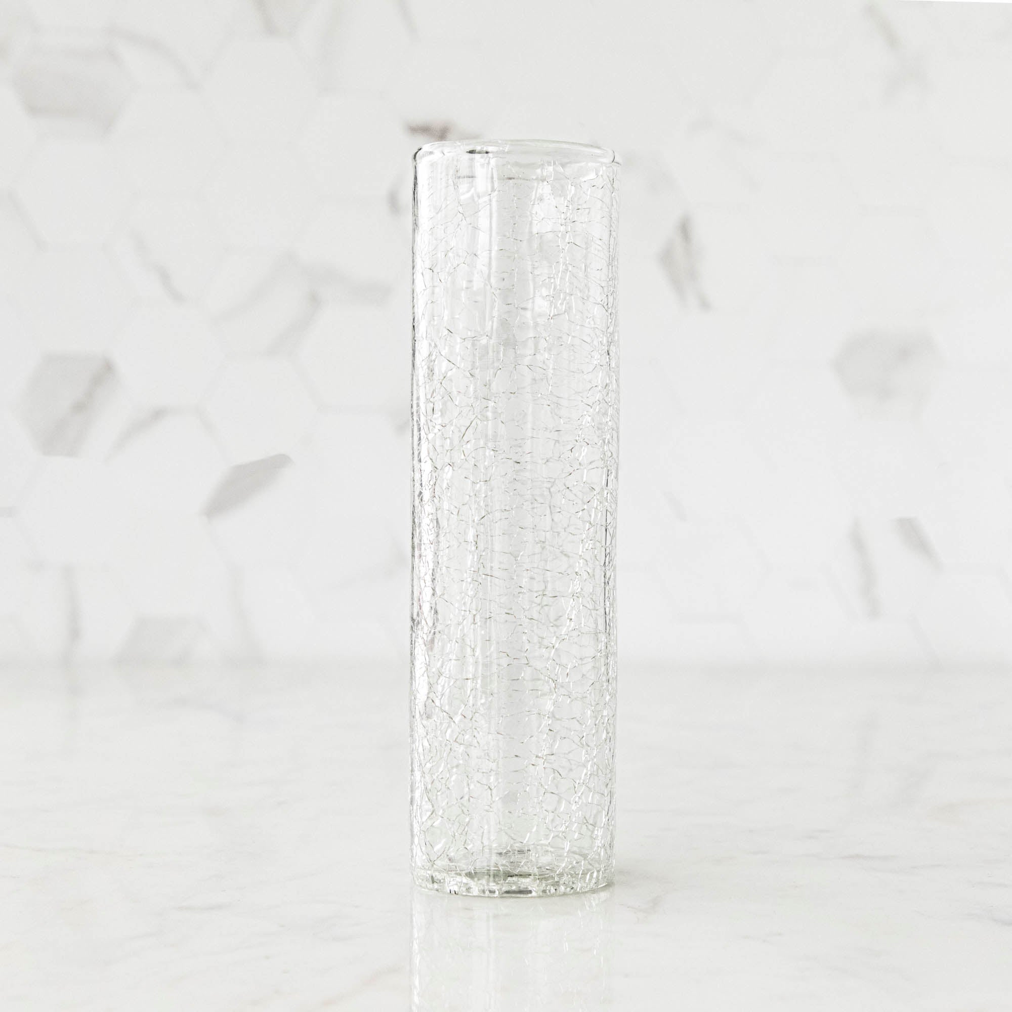 A tall Norwell Champagne Flute sitting on top of a marble counter.