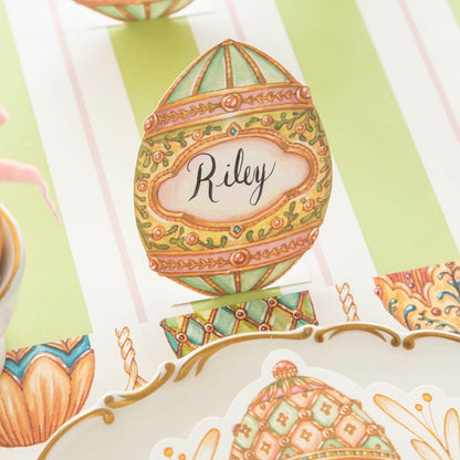 The Exquisite Egg Place Card with &quot;Riley&quot; written on it, on an elegant table setting.