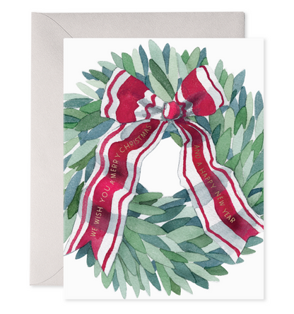 Front of card with illustration of a green wreath with a red &amp; white ribbon tied to it.  In gold foil lettering it says in the ribbon &quot;We wish you a Merry Christmas and a Happy New Year&quot;