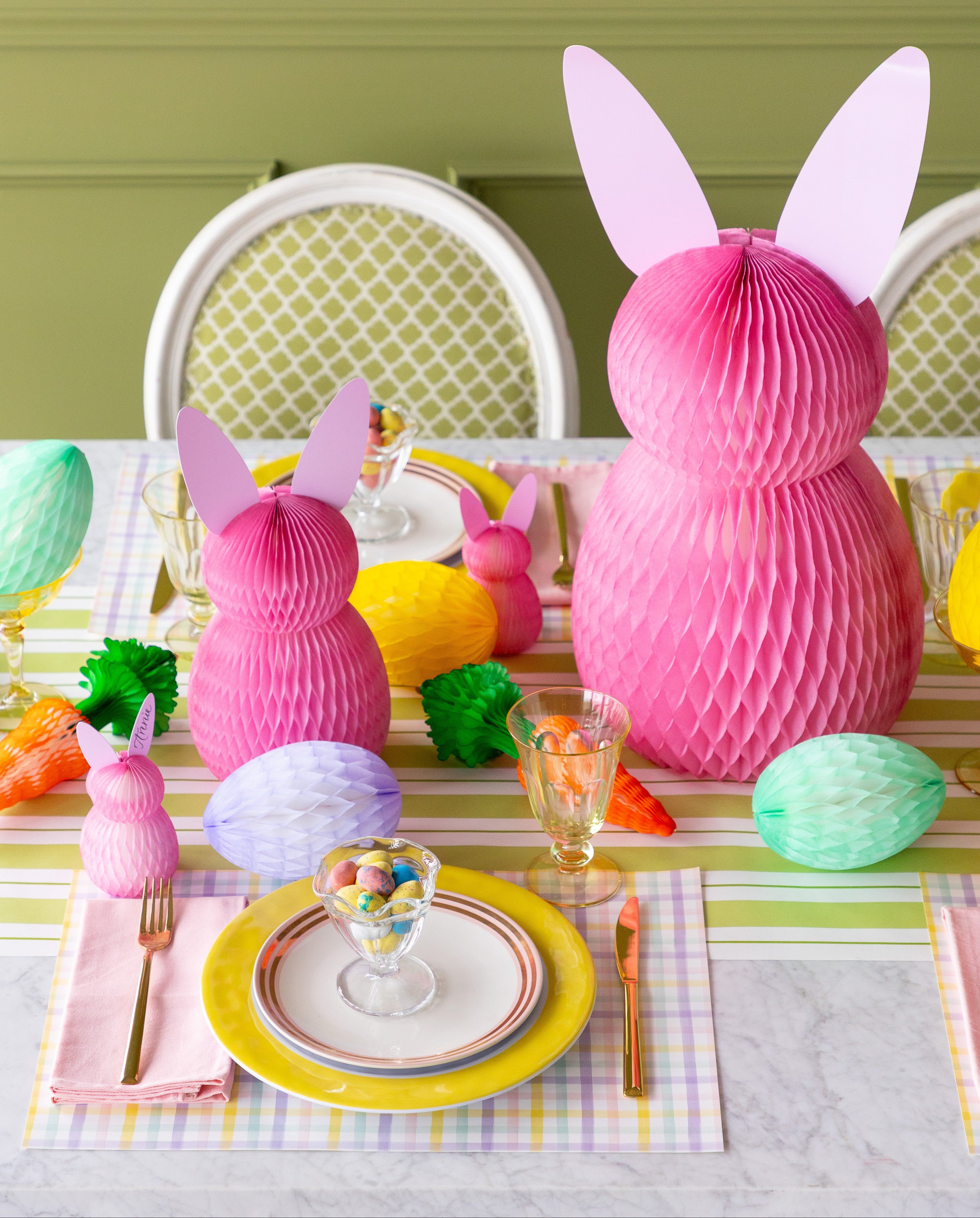 Easter-themed table setting with pink bunny decorations and colorful tableware.
