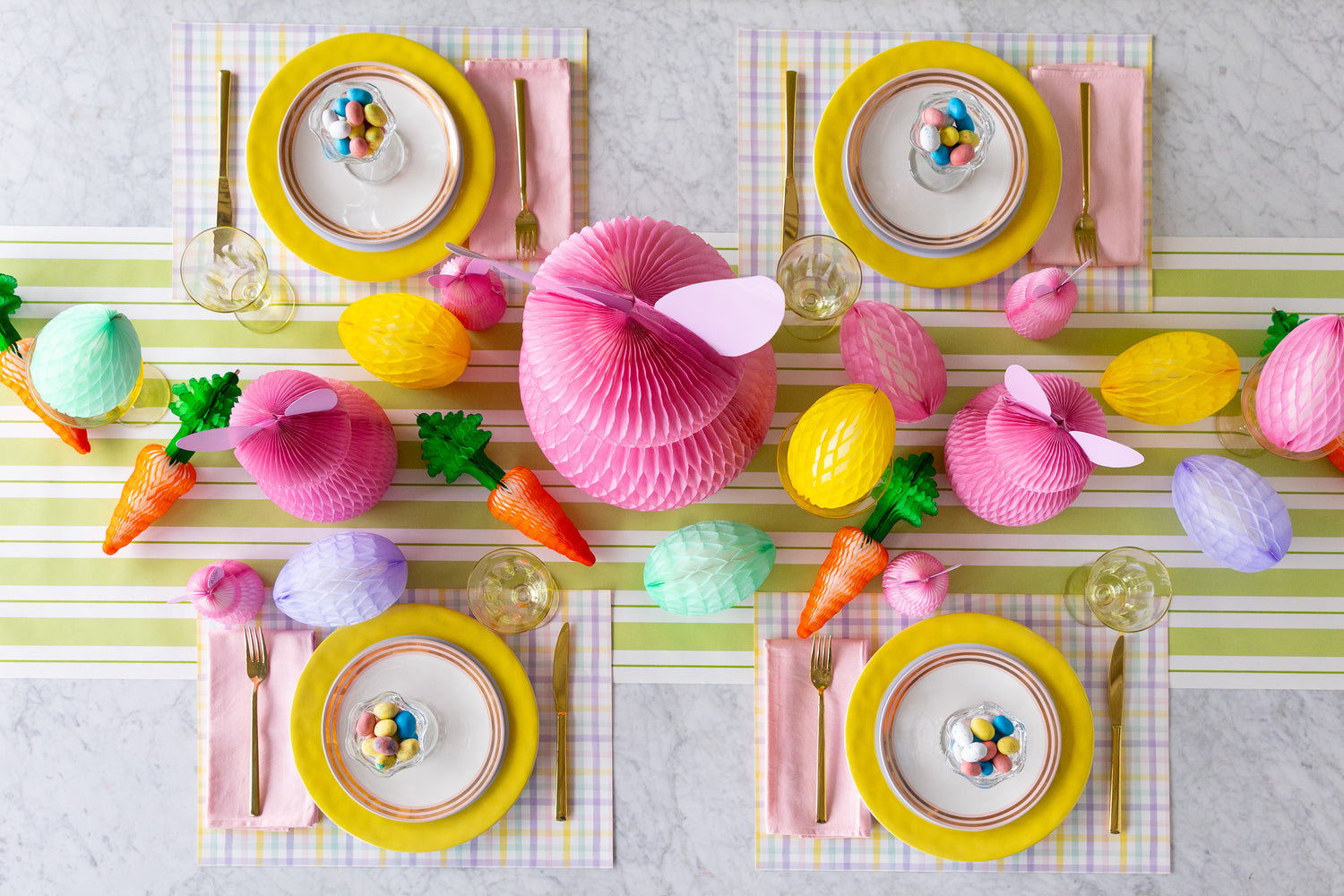 Colorful Easter table setting with pastel decorations and striped table runner.