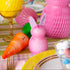 Decorative Easter table setting with colorful honeycomb bunnies, carrots and eggs.