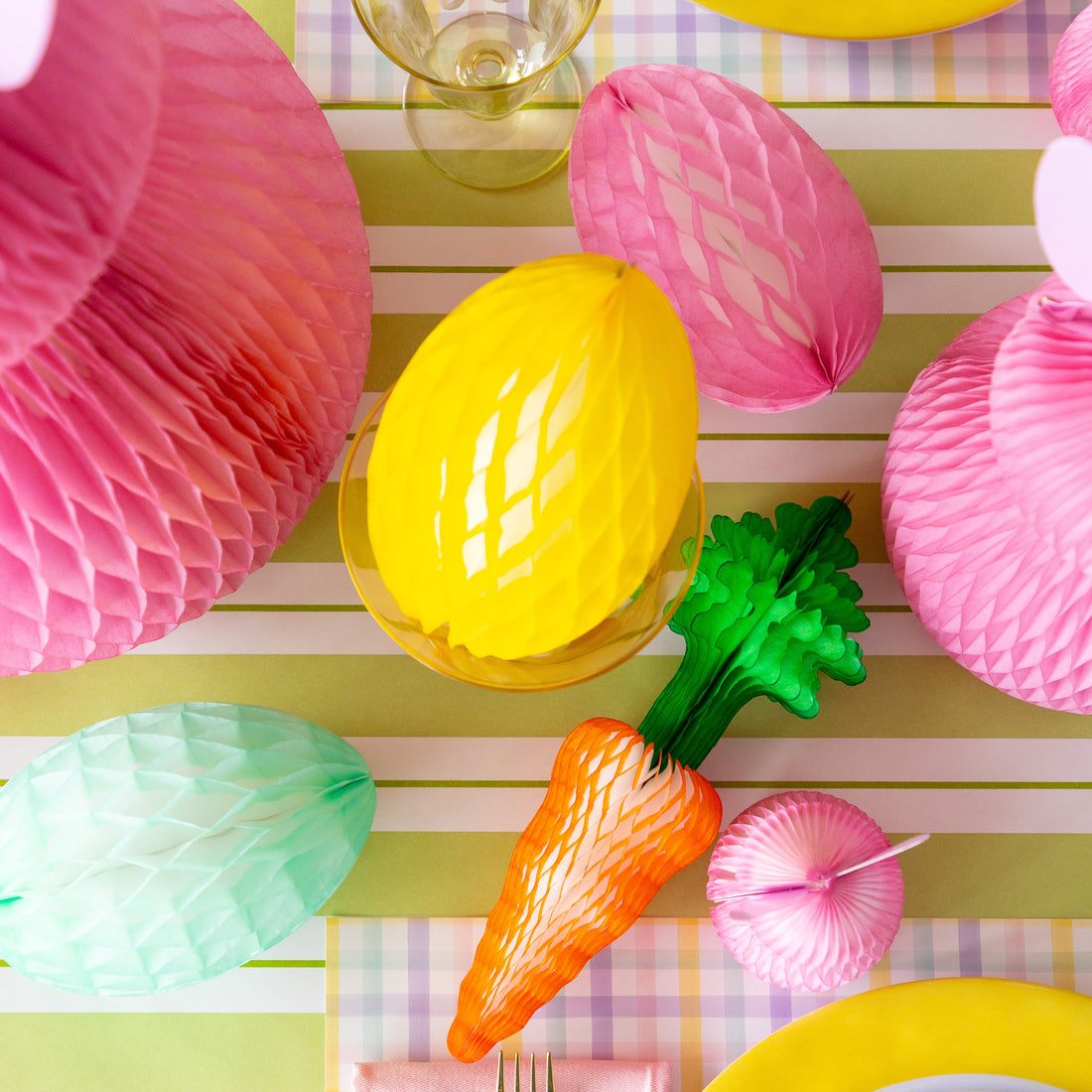 Colorful Easter table setting with Honeycomb Easter Eggs, bunnies and carrots.