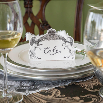 Regal Crest Place Card with &quot;Cole&quot; written on it, sitting upwards on dinner plates.