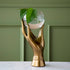 Metal 5.0" x 4.0" x 10.5", hand-shaped terranium holding a glass globe with water and a plant inside.