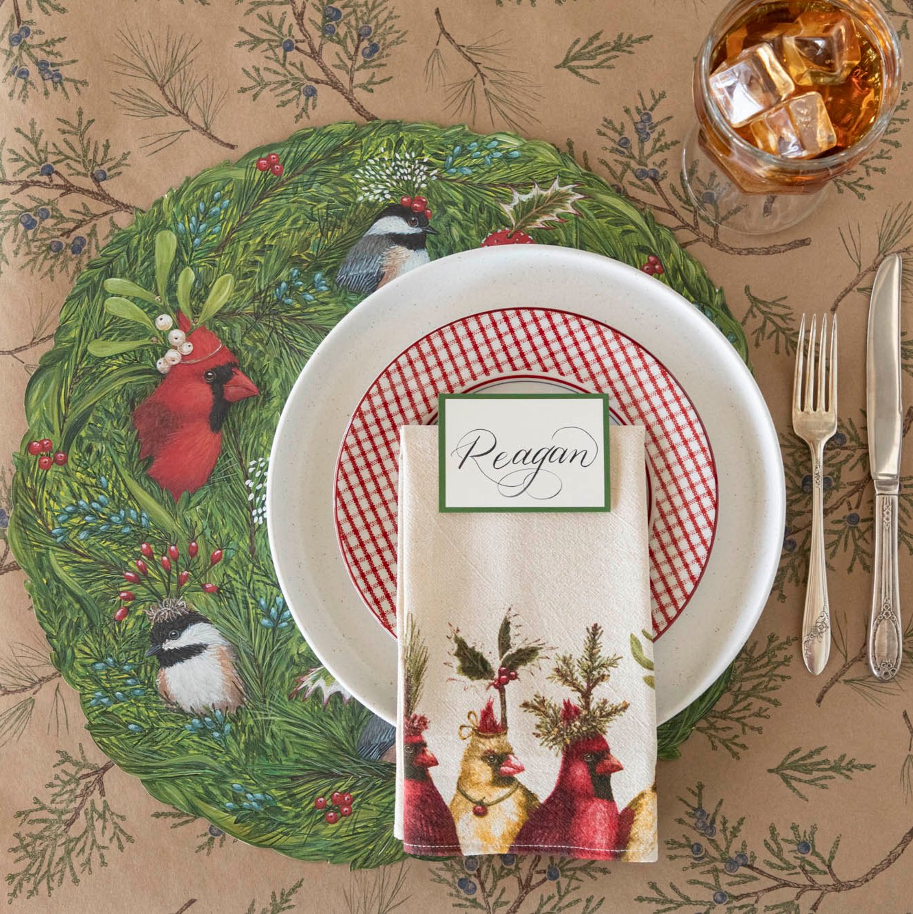 A nature themed table setting featuring the Holiday Party Cardinal Napkin resting on dinner plates.