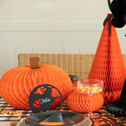  Orange honeycomb pumpkins on a Halloween themed table.