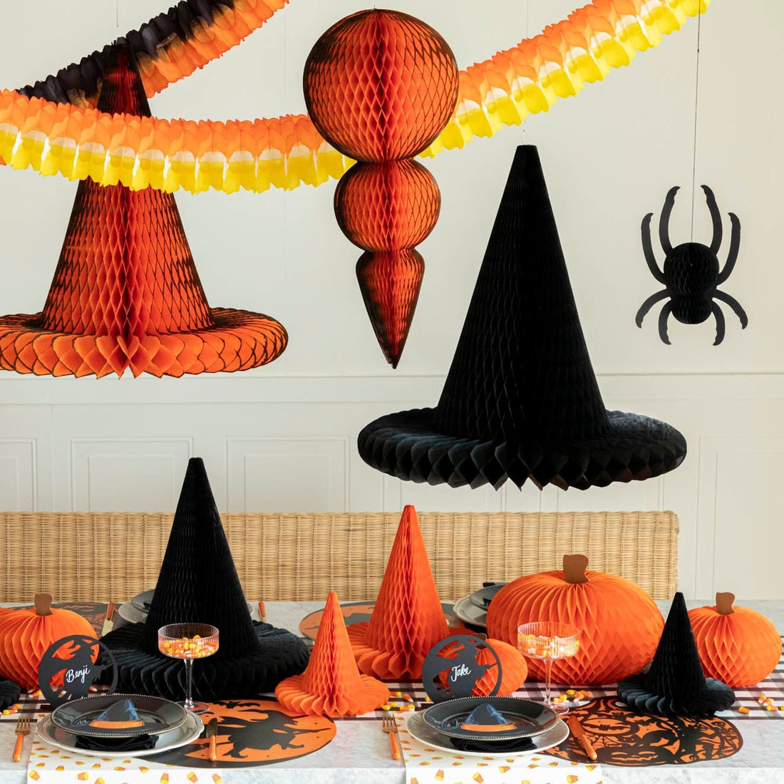 A Halloween themed table setting with Halloween Honeycomb Ornament hanging over the table.