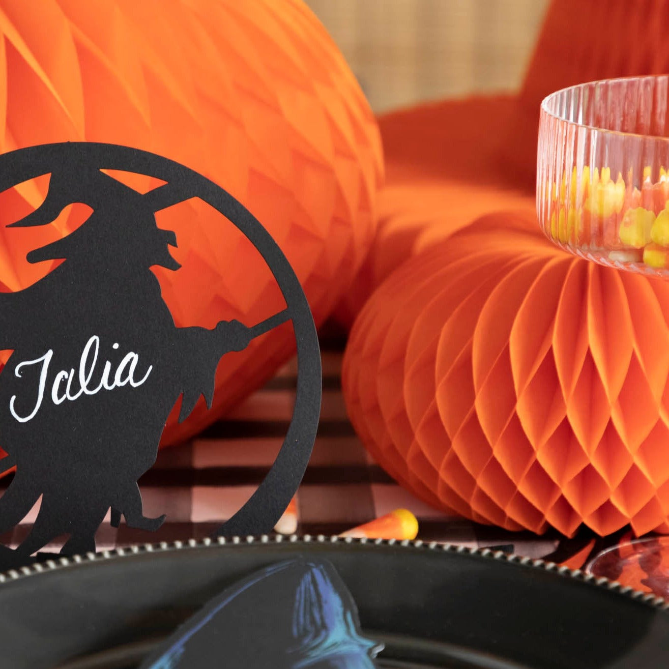 Close up of a orange honeycomb pumpkin on a Halloween themed table.