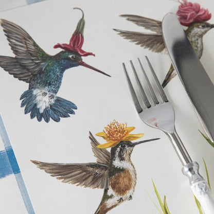 Close-up of the Hummingbirds Placemat under a place setting, showing hummingbirds with flower hats in detail.
