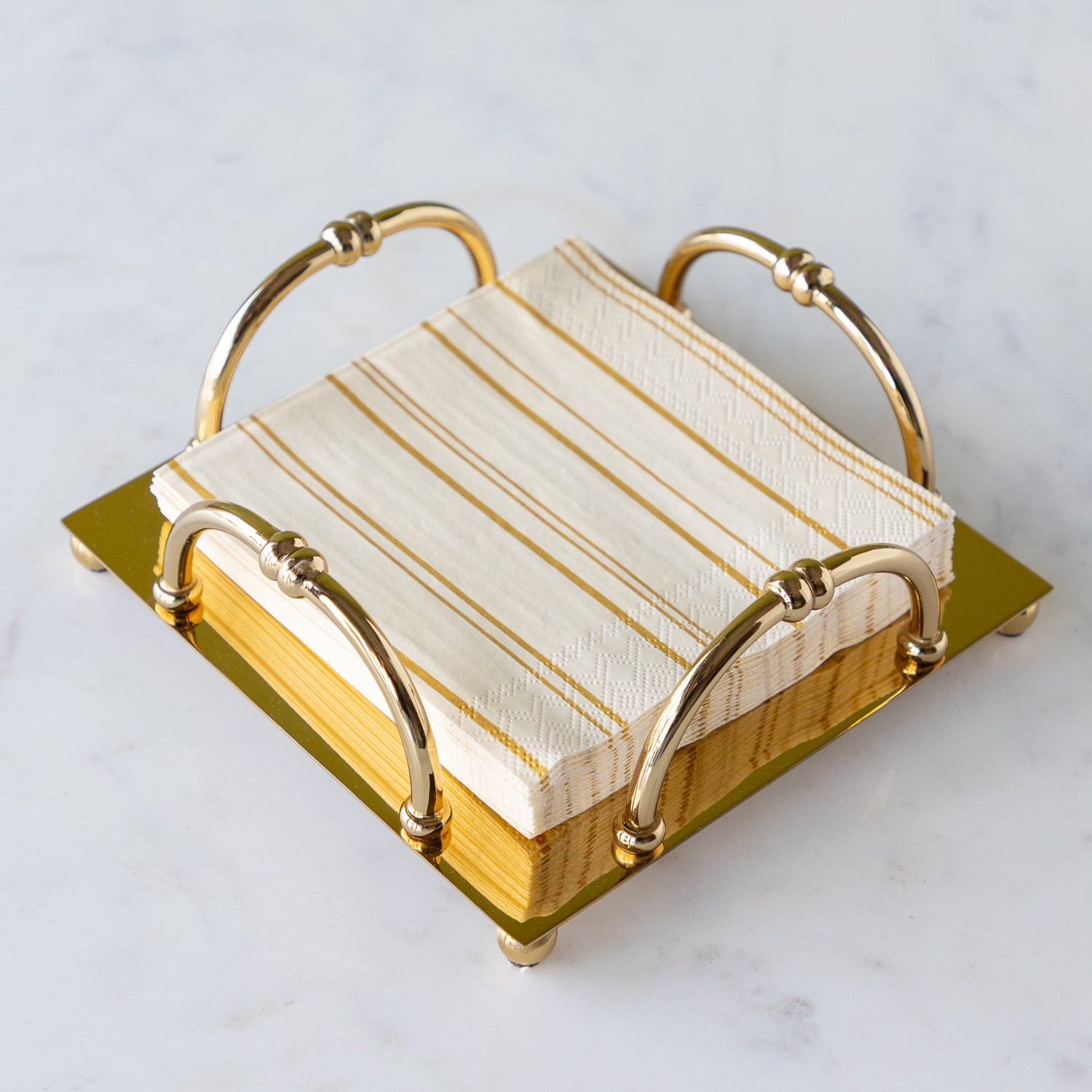 Gold Scalloped Napkin Holder in the cocktail size with Antique Gold Stripe Cocktail Napkins in them.