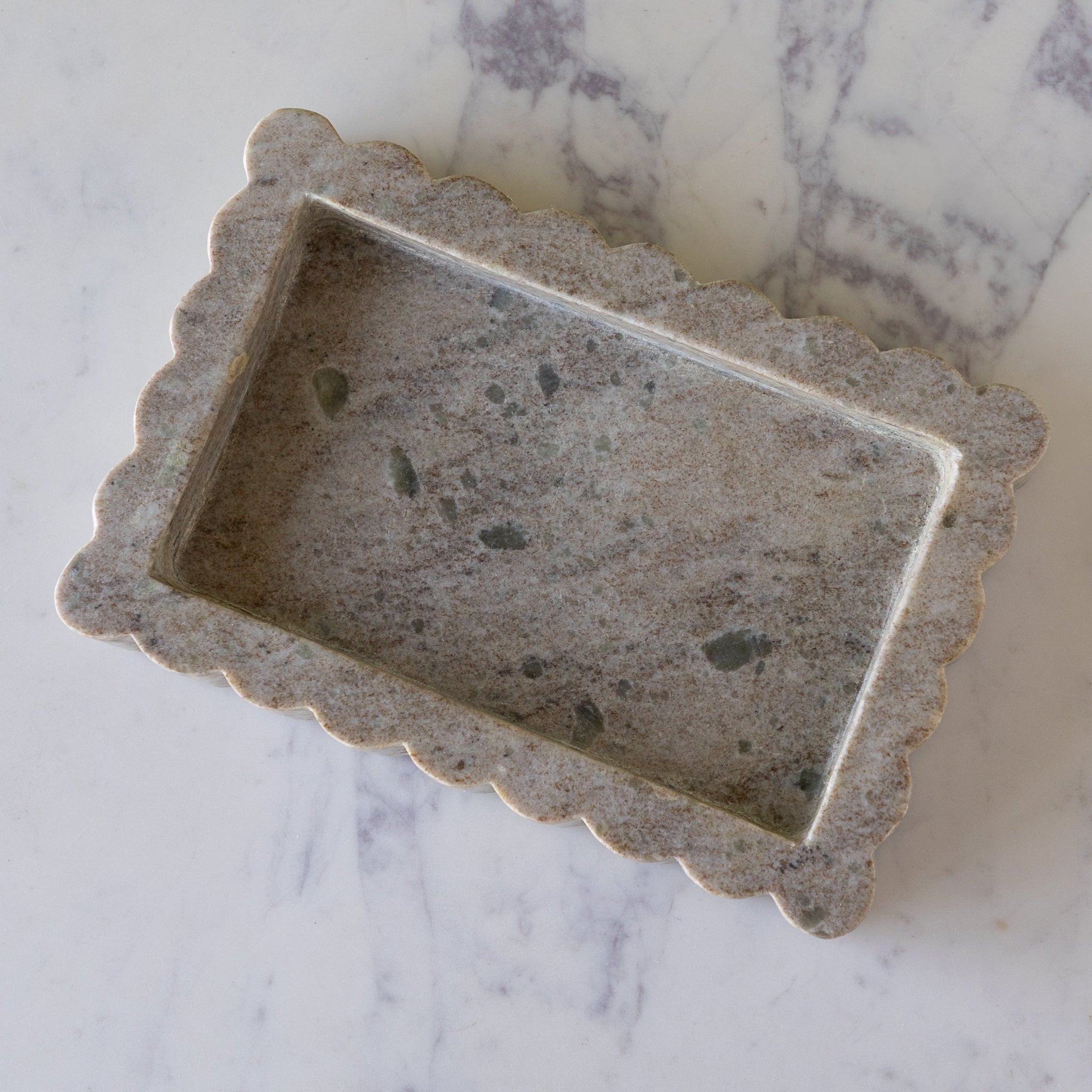 Small Intricate Scallop Marble Tray on a marble surface.