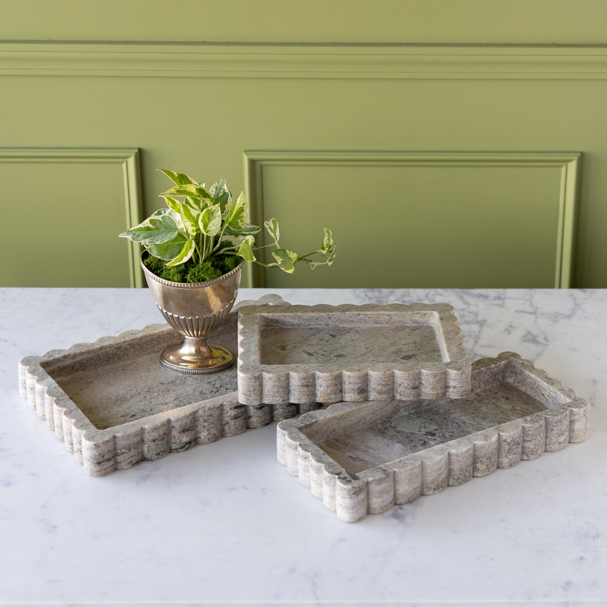 Intricate Scallop Marble Trays in 3 sizes with a potted plant in one.