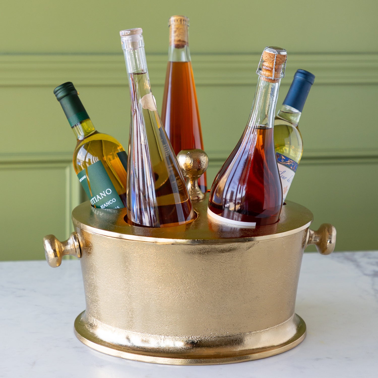 Gold Raw Aluminum Bottle Holder with 5 wine bottles, a knob in the center and on both sides of the bucket.