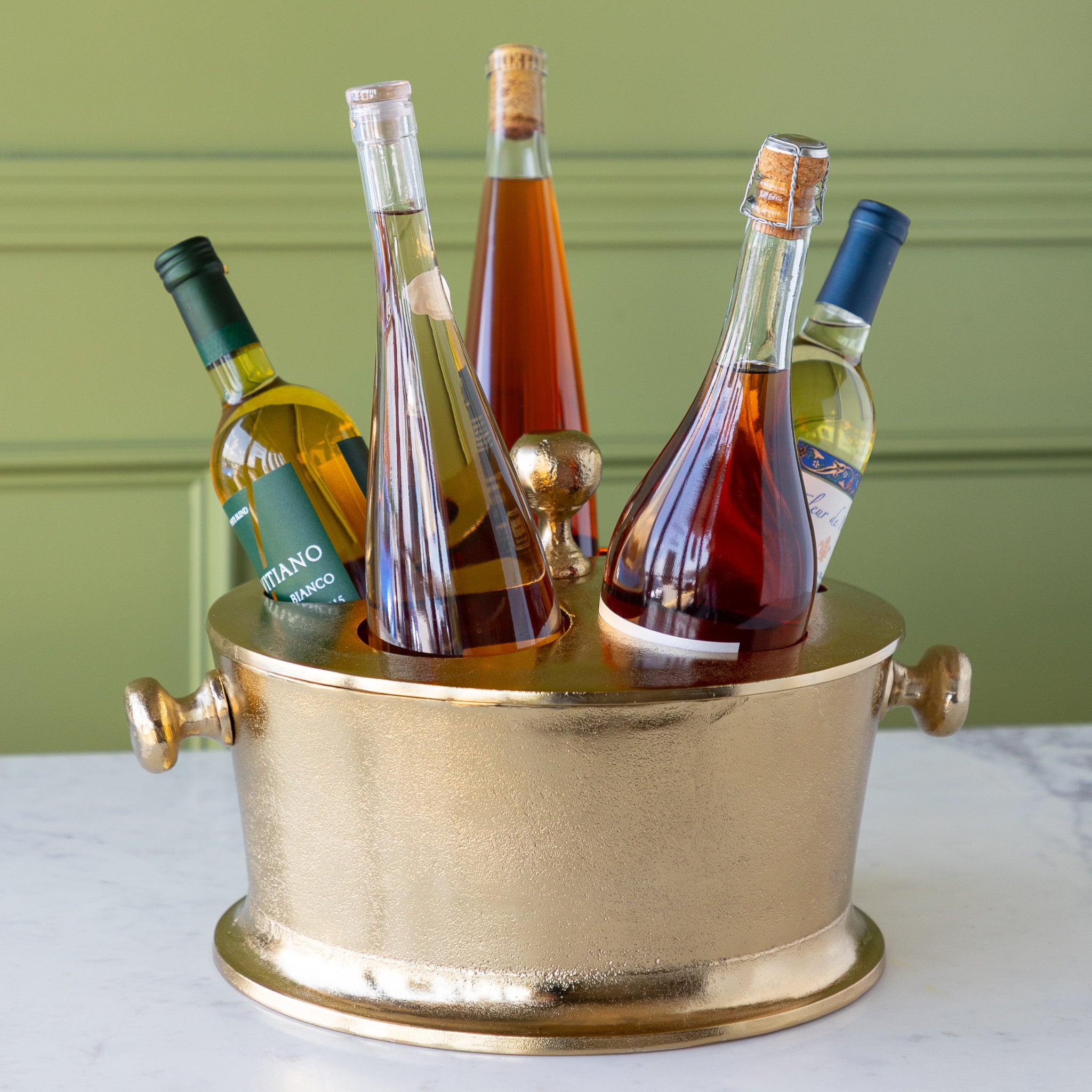 Gold Raw Aluminum Bottle Holder with 5 wine bottles, a knob in the center and on both sides of the bucket.