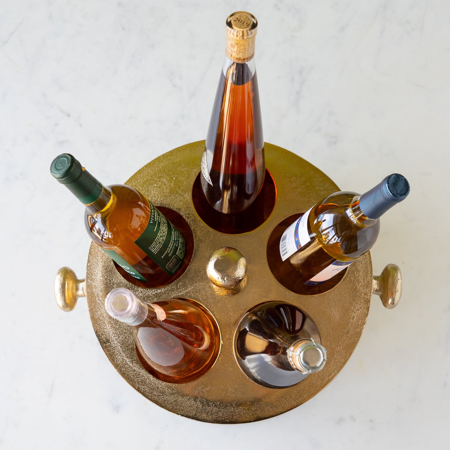 Gold Raw Aluminum Bottle Holder with 5 wine bottles, a knob in the center and on both sides of the bucket.