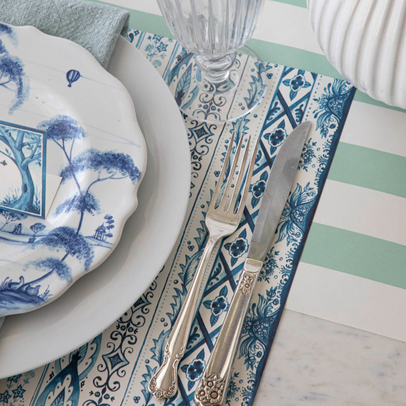 Close-up of the Indigo Chintz Placemat under an elegant place setting.