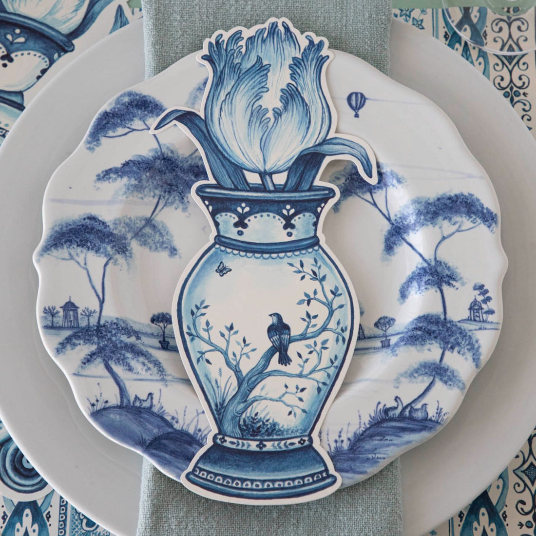 A versatile Indigo Tulip Table Accent by Hester &amp; Cook, this blue and white plate with a bird on it adds a decorative touch to any space.