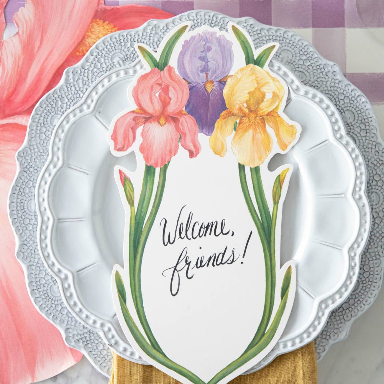 The pink Die-cut Iris Placemat under a vibrant springtime place setting, from above.