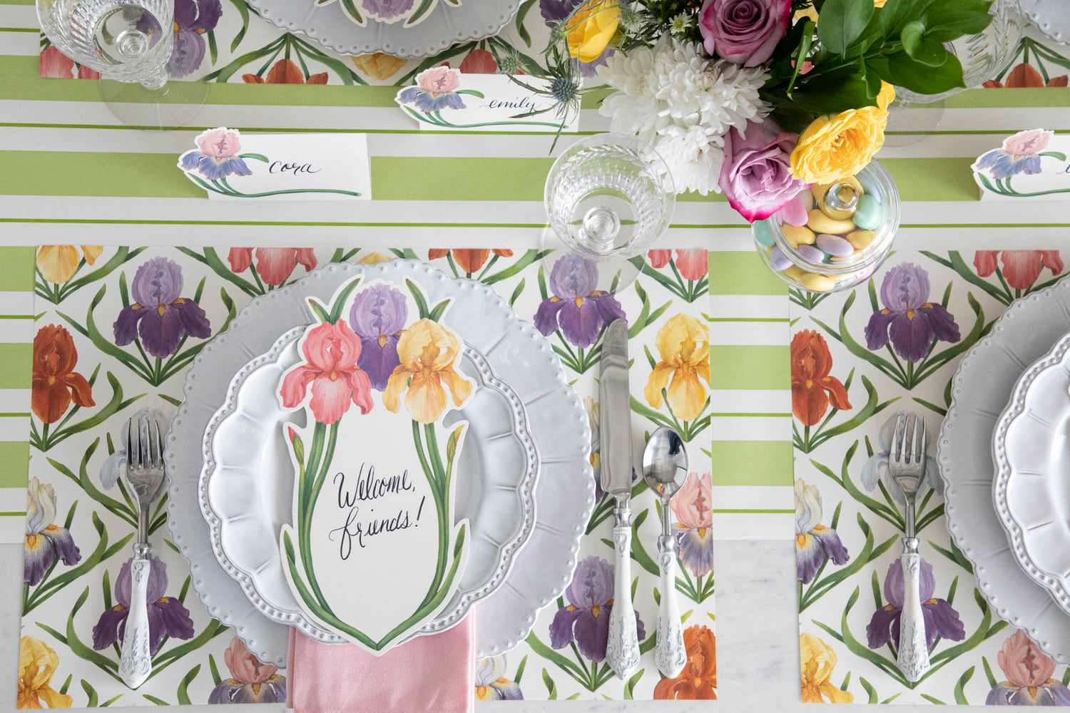 Top-down view of an elegant floral tablescape with Iris Place Cards at each place setting.