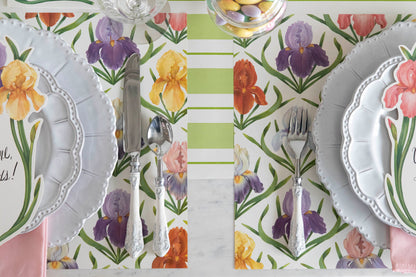 Close-up of the Field of Irises Placemat under two elegant spring-themed place settings, from above.