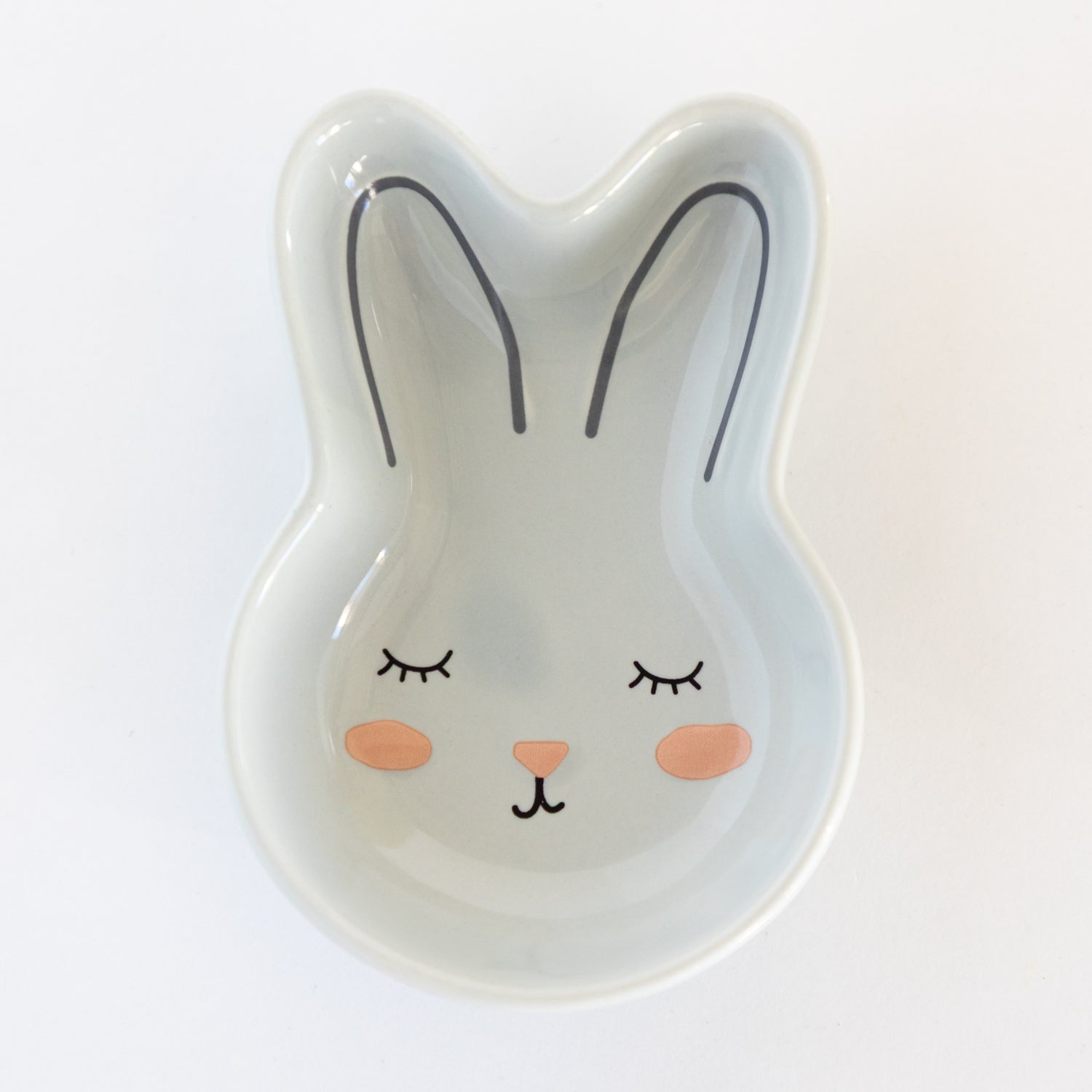Light gray, ceramic rabbit-shaped bowl with a face on a white background.