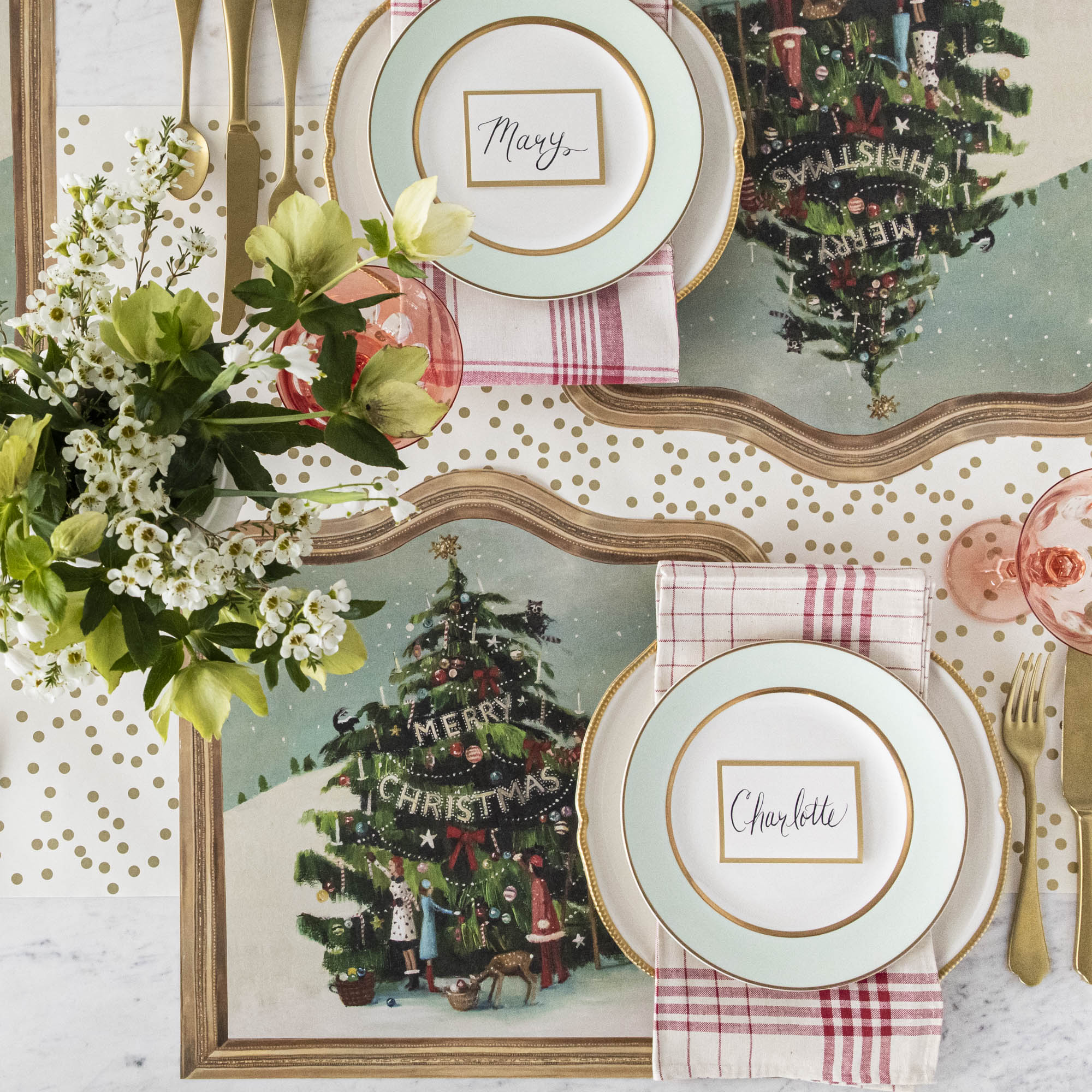 The Die-cut Trim the Tree Placemat under an elegant Christmas-themed table setting, from above.