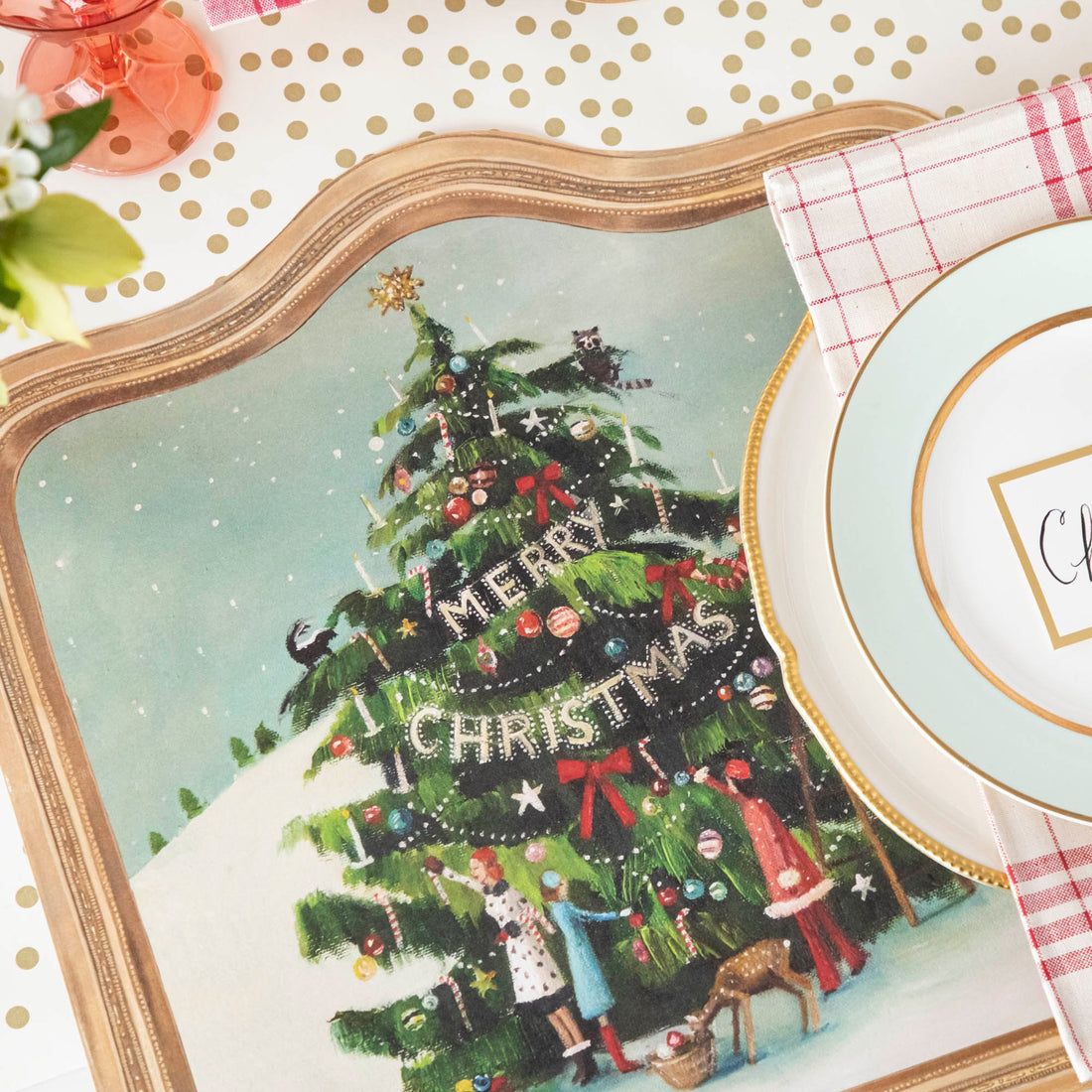 The Die-cut Trim the Tree Placemat under an elegant Christmas-themed place setting.