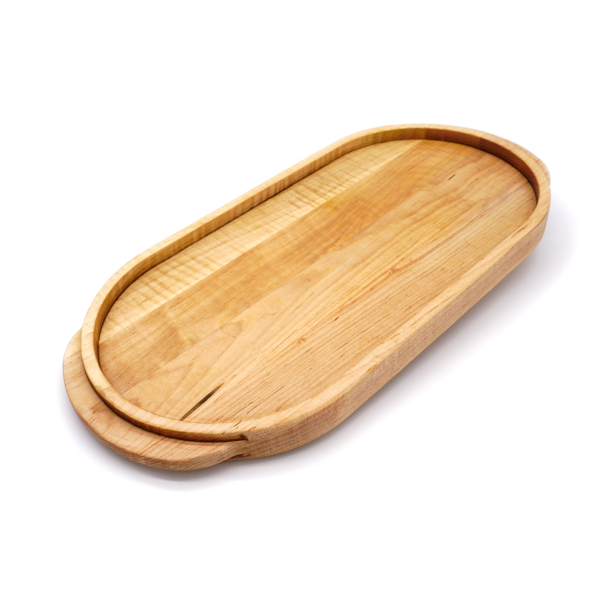 A JK Adams Maple Oval Wooden Serving Tray with food on it.