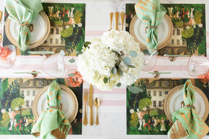 A top-down view of an elegant tablescape featuring High Kick Place Cards behind each plate.
