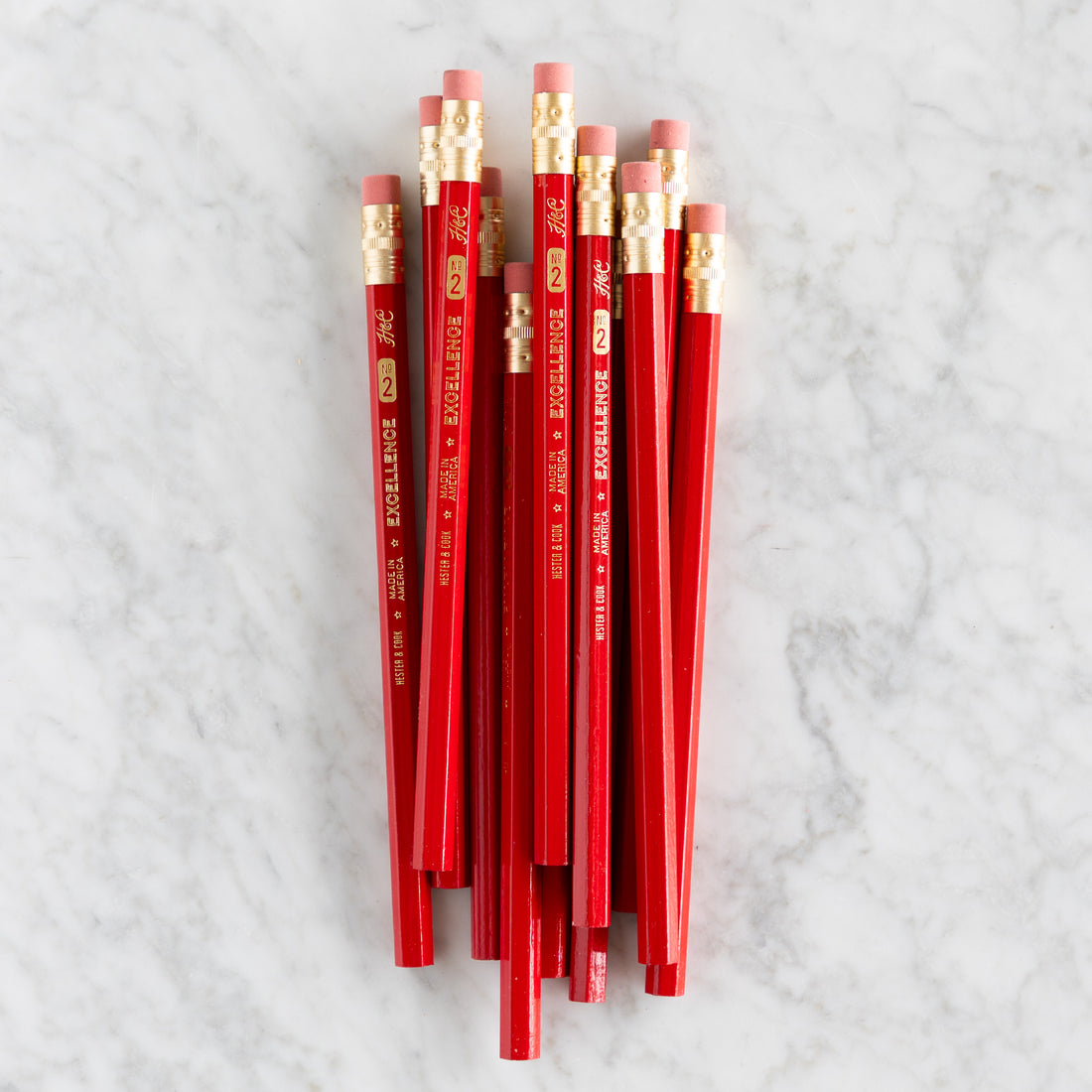 Jumbo Hex Red Pencils grouped together on a marble background. 