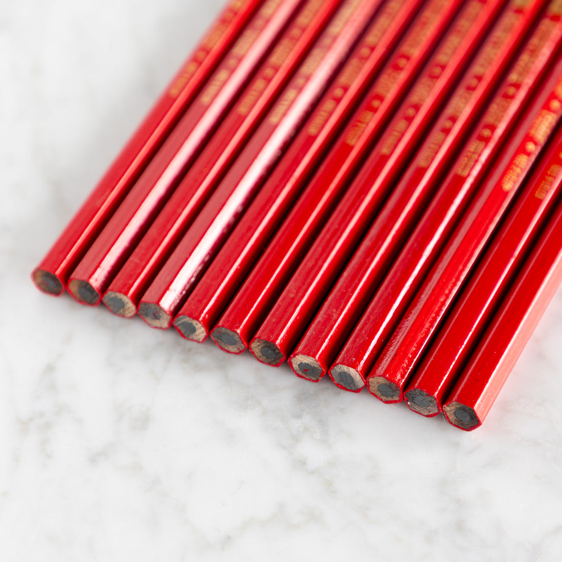 Close up of the ends of Jumbo Hex Red Pencils. 